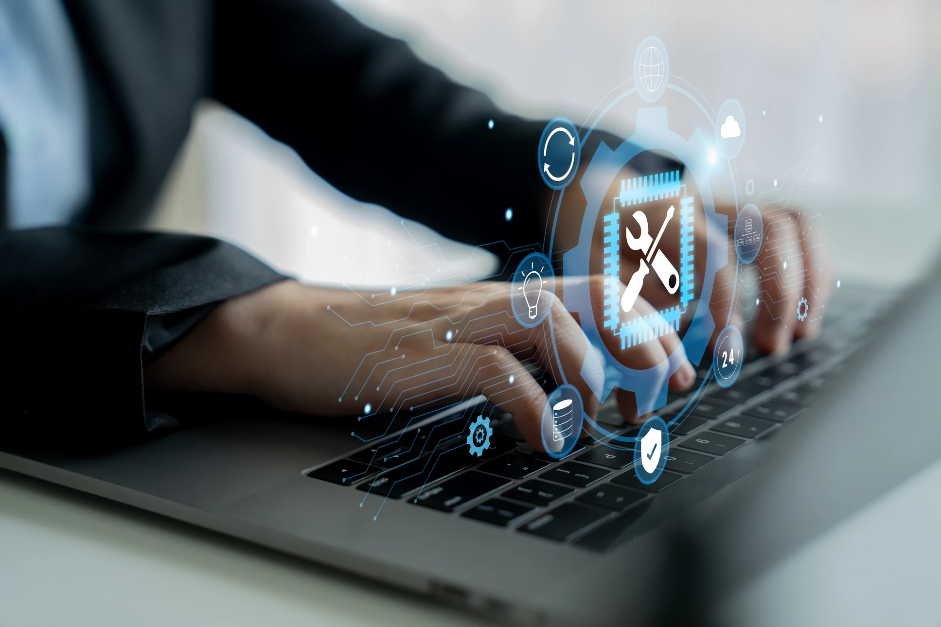Jeune homme en chemise à carreaux travaillant dans un bureau moderne avec ordinateur portable et tablette graphique